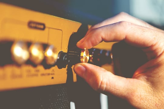 Hand guitarist and guitar amplifier detail
