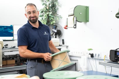 Man holding a wire spool